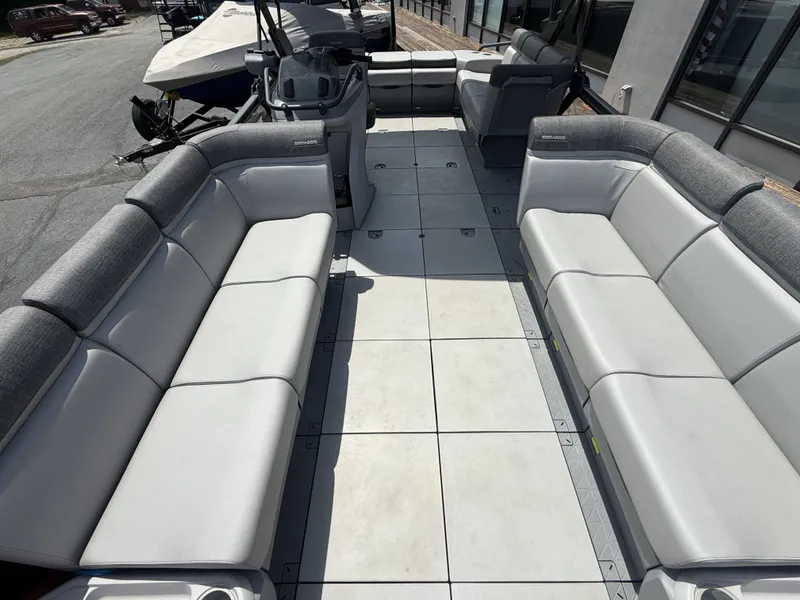 Slide: The Image of The image shows the spacious deck of a 2023 Sea-Doo Switch Cruise with gray and white seating. - 8