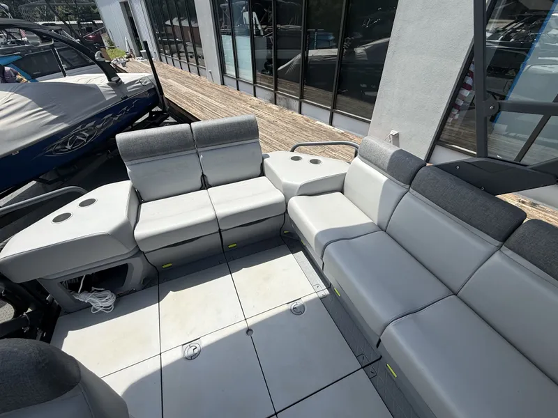 Slide: The Image of The image shows the spacious seating area of a 2023 Sea-Doo Switch Cruise with gray upholstery. - 14