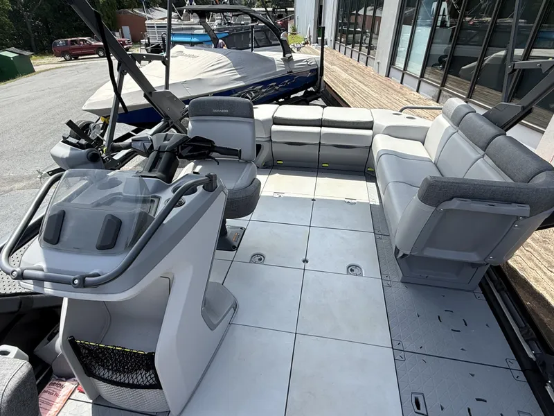 Slide: The Image of The image shows the spacious deck of a 2023 Sea-Doo Switch Cruise with gray seating. - 11