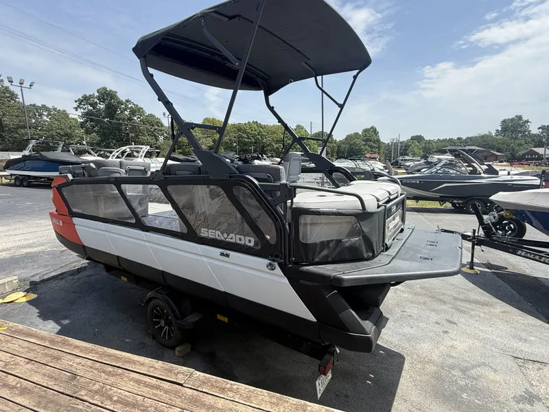 Slide: The Image of A 2023 Sea-Doo Switch Cruise with a black canopy and gray seating, parked on a trailer. - 4