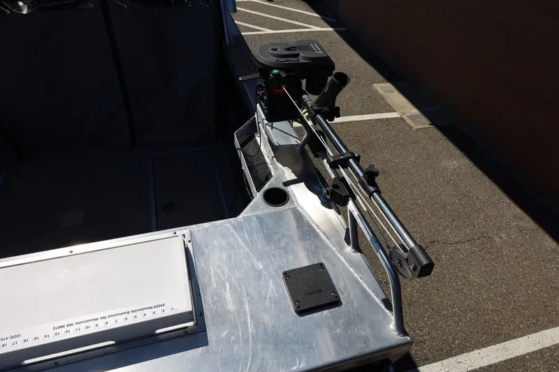 Slide: The Image of 2025 Thunder Jet 200 Luxor boat with fishing rod holder, parked in a lot. - 19