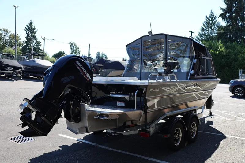 Slide: The Image of 2025 Thunder Jet 200 Luxor boat with Mercury outboard motor in a parking lot. - 7