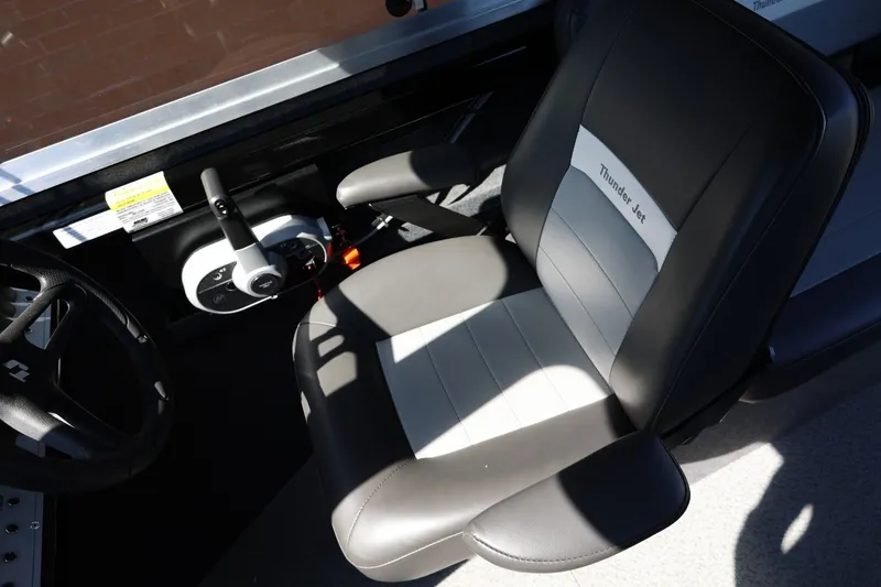 Slide: The Image of Interior of 2025 Thunder Jet 200 Luxor boat, featuring steering wheel and branded seat. - 43
