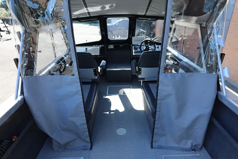 Slide: The Image of Interior view of 2025 Thunder Jet 200 Luxor boat, featuring seating and navigation controls. - 34