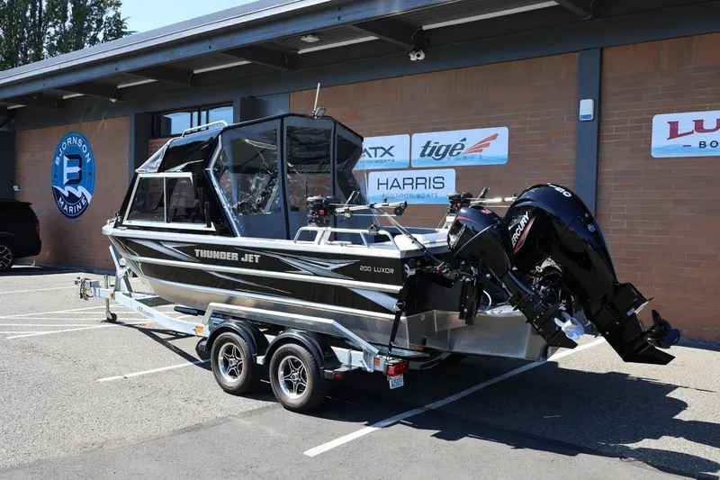 Slide: The Image of 2025 Thunder Jet 200 Luxor boat on trailer, parked outside marine dealership. - 3
