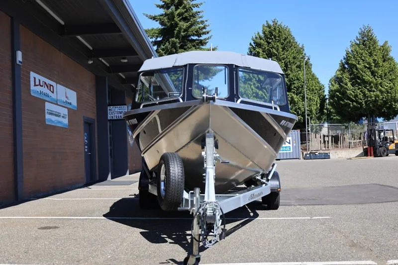 Slide: The Image of 2025 Thunder Jet 200 Luxor boat on trailer outside dealership, sunny day. - 13