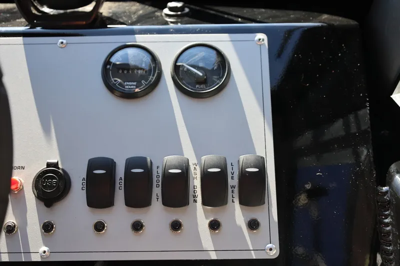 Slide: The Image of Control panel of 2025 Thunder Jet 200 Luxor boat with switches and gauges. - 46