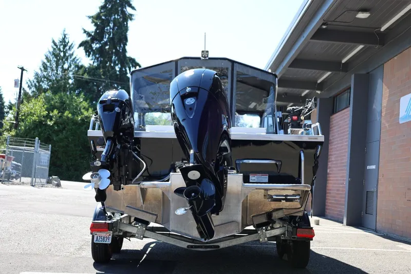 Slide: The Image of 2025 Thunder Jet 200 Luxor boat with dual outboard motors, parked outdoors. - 6