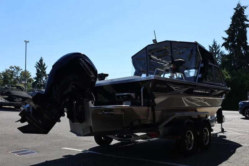 Slide: The Image of 2025 Thunder Jet 200 Luxor boat with Mercury engine, parked outdoors on a sunny day. - 8