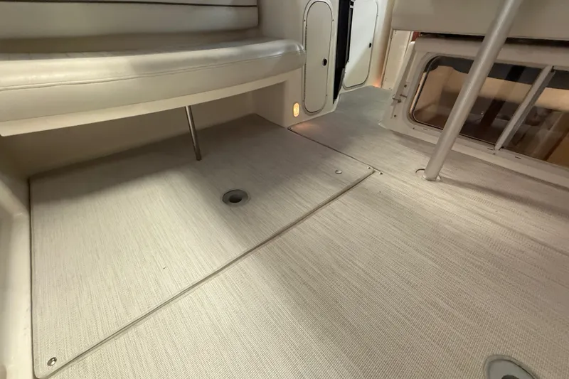 Slide: The Image of Interior of 2005 Maxum 3300 SE boat, featuring seating and flooring details. - 17