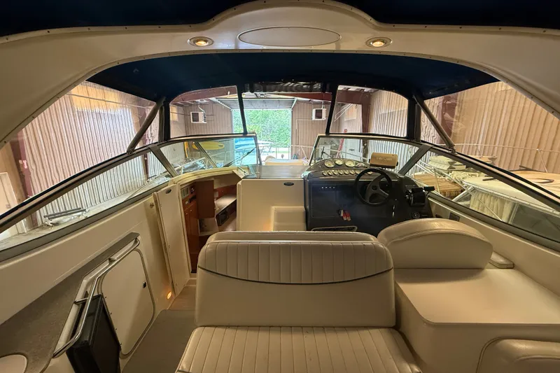 Slide: The Image of 2005 Maxum 3300 SE boat interior with helm, seating, and cabin view. - 11