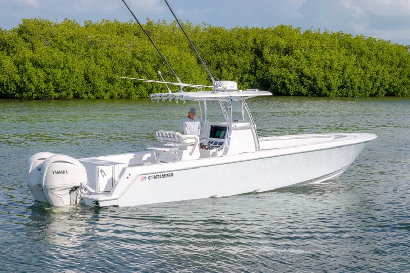 Slide: The Image of 2024 Contender 32 ST boat with Yamaha engines on calm water. - 7