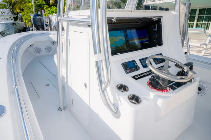 Slide: The Image of 2024 Contender 32 ST boat cockpit with advanced navigation system and sleek steering wheel. - 15
