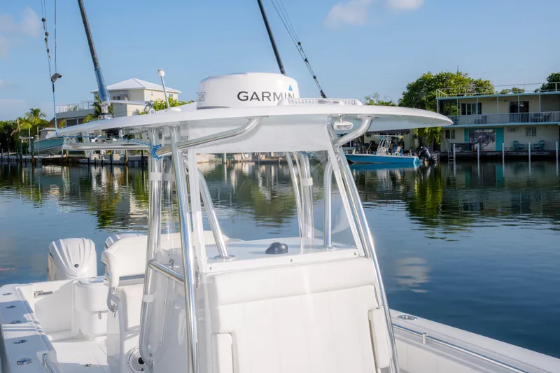 Slide: The Image of 2024 Contender 32 ST boat with Garmin equipment, docked in a serene waterfront setting. - 18