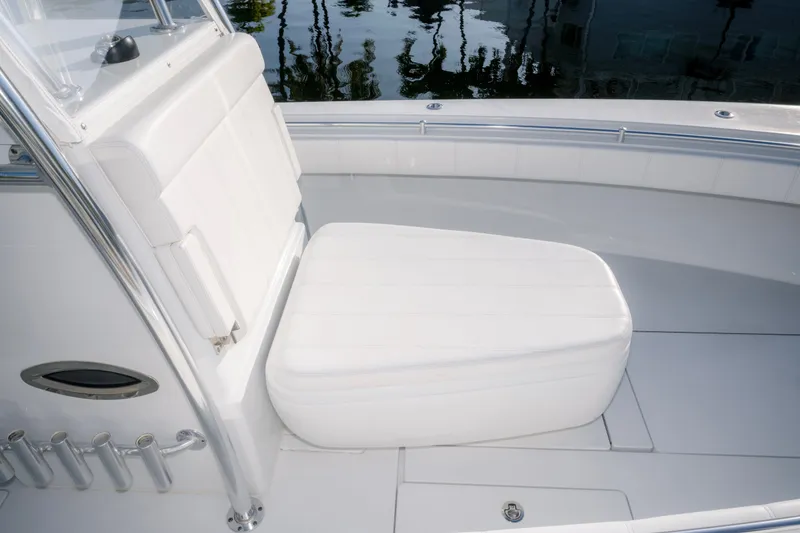 Slide: The Image of 2024 Contender 32 ST boat interior with white cushioned seating and stainless steel accents. - 16