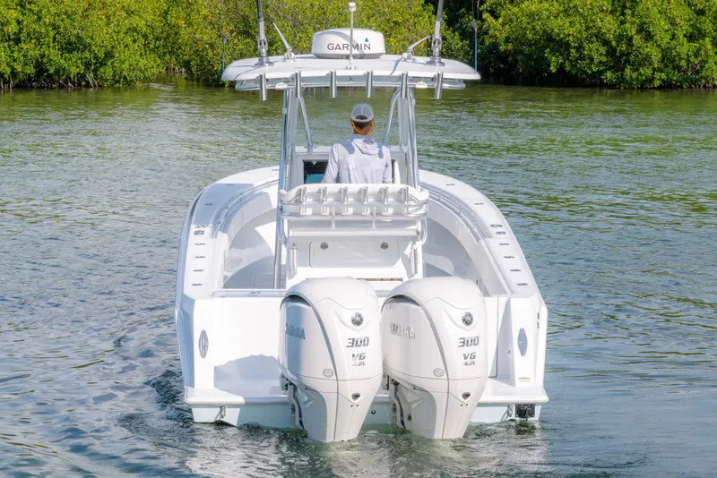 Slide: The Image of 2024 Contender 32 ST boat with dual Yamaha engines on calm water. - 9