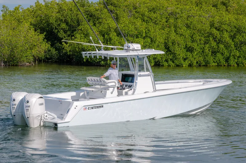 Slide: The Image of 2024 Contender 32 ST boat with dual Yamaha engines on calm water. - 5