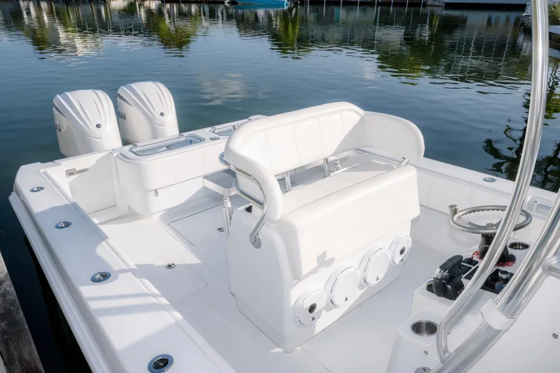 Slide: The Image of 2024 Contender 32 ST boat with dual engines, sleek white design, and modern seating. - 11