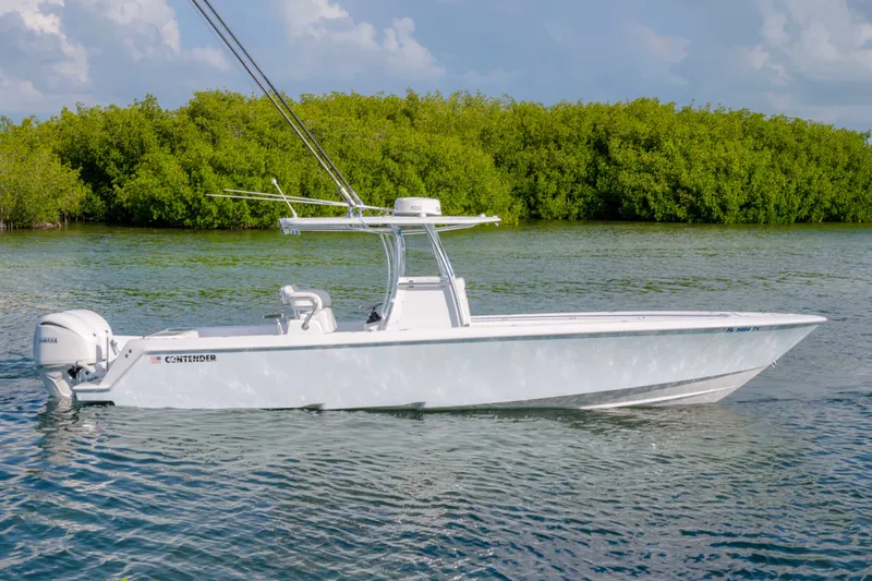 The Image of 2024 Contender 32 ST boat on calm water with lush green mangroves in the background. - 0