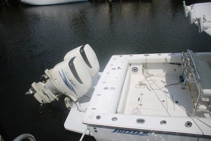 Slide: The Image of 1996 Jupiter 31 Center Console boat with twin Suzuki outboard engines on calm water. - 19