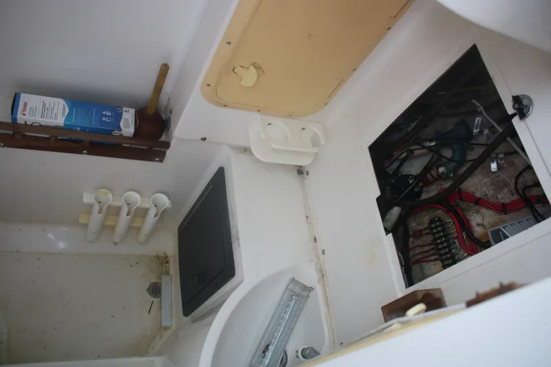 Slide: The Image of Interior view of a 1996 Jupiter 31 Center Console boat showing storage and wiring compartments. - 8