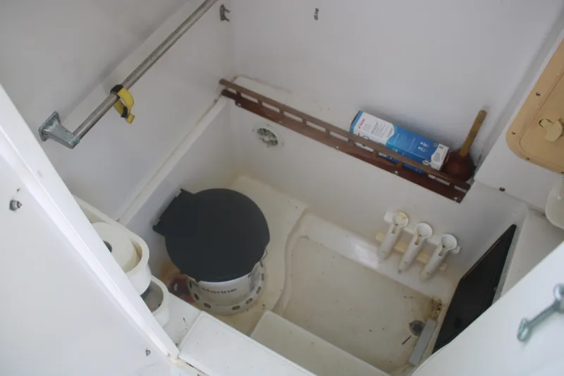 Slide: The Image of Interior of a 1996 Jupiter 31 Center Console boat showing storage and plumbing area. - 9
