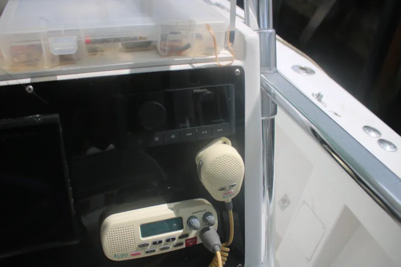 Slide: The Image of Control panel of a 1996 Jupiter 31 Center Console boat with radio equipment. - 17