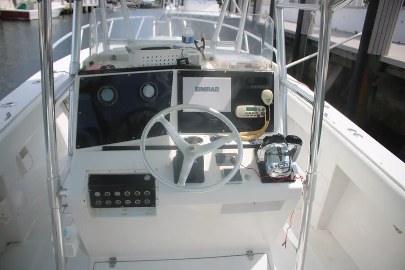 Slide: The Image of 1996 Jupiter 31 Center Console boat helm with steering wheel and navigation equipment. - 7
