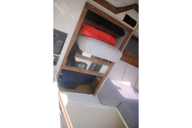 Slide: The Image of Interior view of a 1996 Jupiter 31 Center Console boat with storage compartments. - 13
