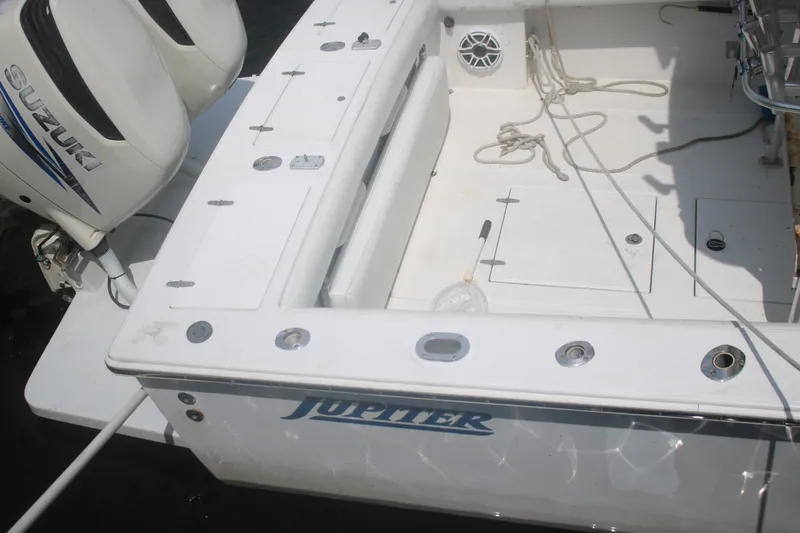Slide: The Image of 1996 Jupiter 31 Center Console boat with Suzuki engines, featuring a spacious deck layout. - 16