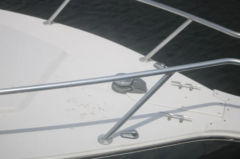 Slide: The Image of Bow of a 1996 Jupiter 31 Center Console boat with stainless steel railings. - 4