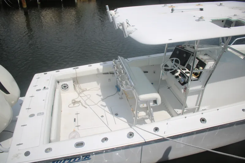 Slide: The Image of 1996 Jupiter 31 Center Console boat with spacious deck and modern controls. - 18