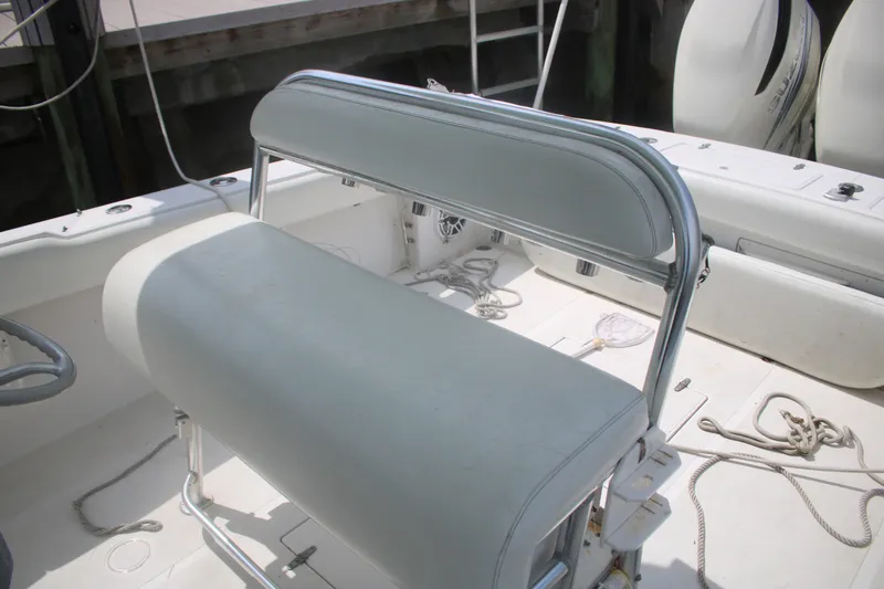 Slide: The Image of 1996 Jupiter 31 Center Console boat interior with white seating and ropes. - 21