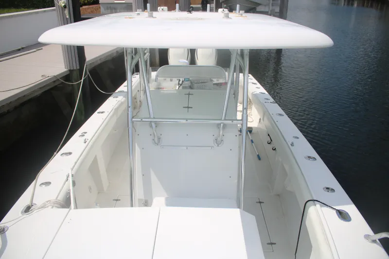 Slide: The Image of 1996 Jupiter 31 Center Console boat docked, featuring spacious deck and T-top. - 15