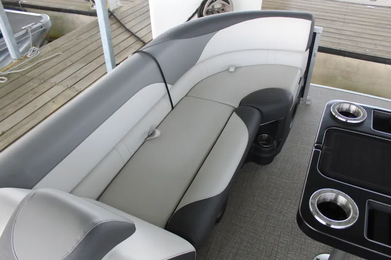 Slide: The Image of The image shows an elegant seating area on a boat with gray and white upholstery. - 15