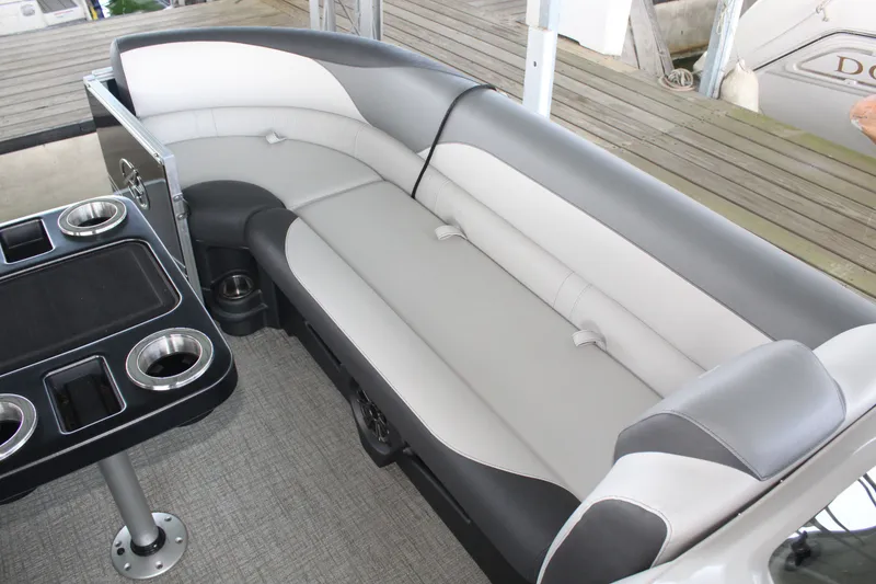 Slide: The Image of The image shows a sleek gray and white seating area on a boat, with cup holders nearby. - 16