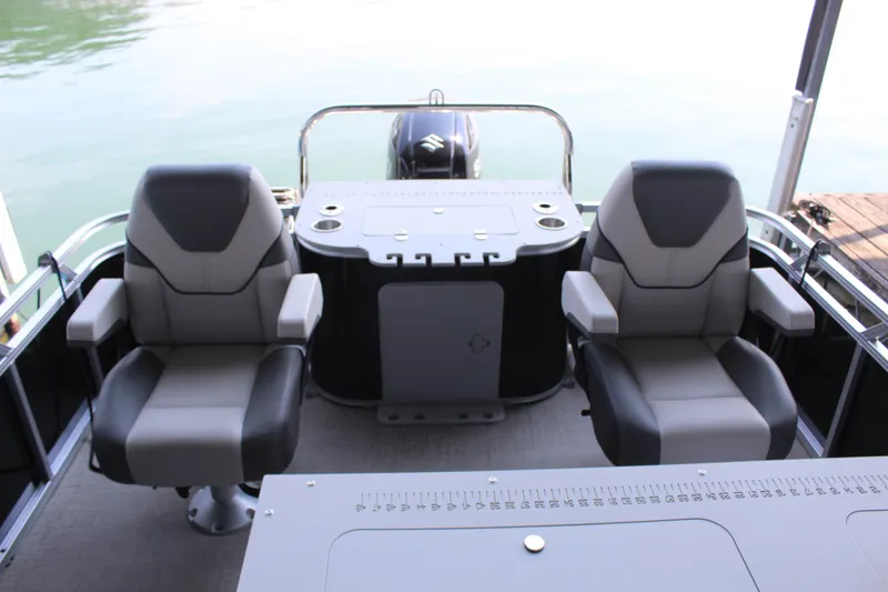 Slide: The Image of Two cushioned seats on a boat with an engine in the background. - 12