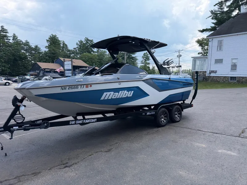 Slide: The Image of A 2025 Malibu Wakesetter 22 MXZ on a trailer in a parking lot. - 16