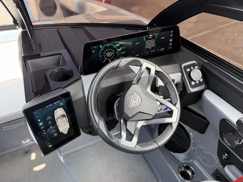 Slide: The Image of The image shows the modern cockpit of a 2025 Malibu Wakesetter 22 MXZ with digital display. - 20