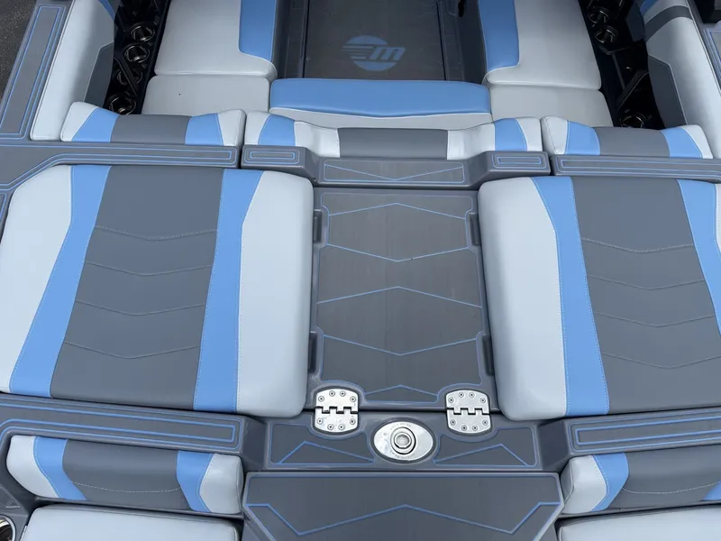 Slide: The Image of The image shows the stylish, cushioned deck of a 2025 Malibu Wakesetter 22 MXZ. - 26