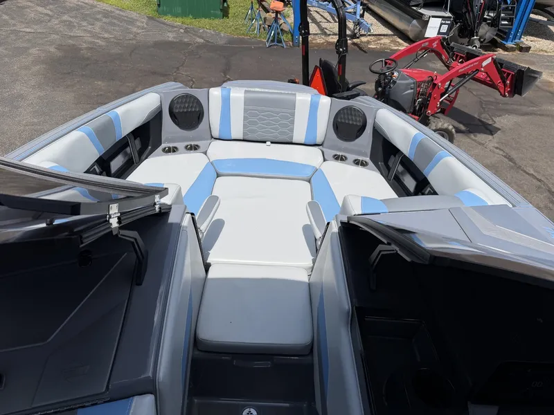 Slide: The Image of The image shows the cockpit of a 2025 Malibu Wakesetter 22 MXZ with gray and blue upholstery. - 25