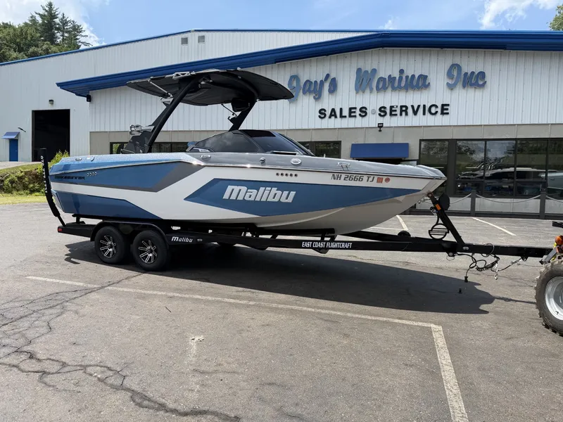 Slide: The Image of A 2025 Malibu Wakesetter 22 MXZ on a trailer in front of a building labeled "Jay's Marina Inc." - 6