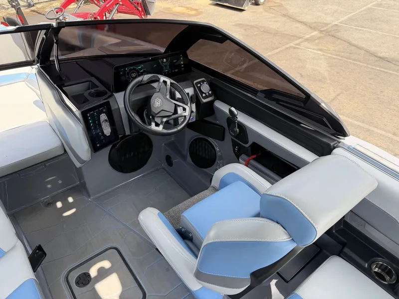 Slide: The Image of The image shows the cockpit of a 2025 Malibu Wakesetter 22 MXZ with modern controls. - 19