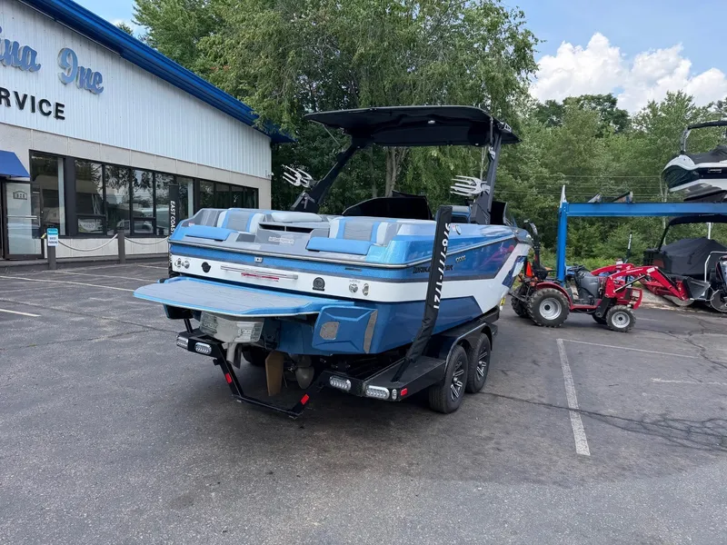 Slide: The Image of A 2025 Malibu Wakesetter 22 MXZ is parked. The blue and white hull is prominently visible. - 11