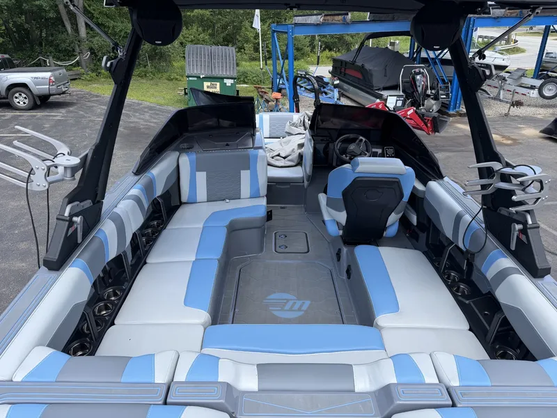 Slide: The Image of The image shows the interior of a 2025 Malibu Wakesetter 22 MXZ with gray and blue seating. - 21
