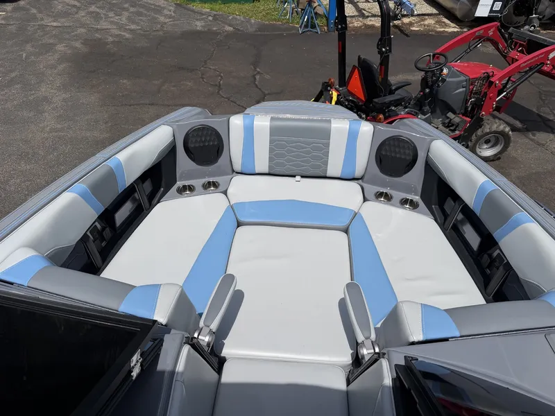 Slide: The Image of The image shows the bow of a 2025 Malibu Wakesetter 22 MXZ with gray and blue upholstery. - 24