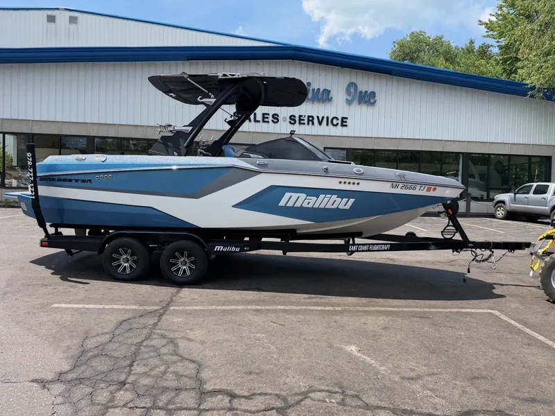 Slide: The Image of A 2025 Malibu Wakesetter 22 MXZ on a trailer in front of a sales building. - 4