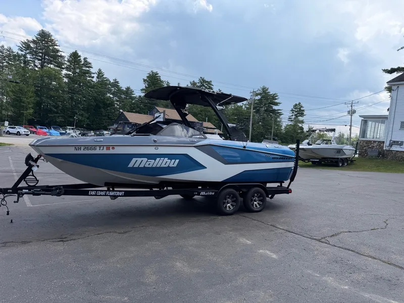 Slide: The Image of A 2025 Malibu Wakesetter 22 MXZ on a trailer in a parking lot. - 15
