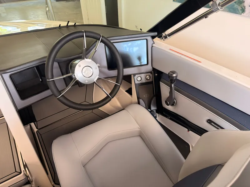 Slide: The Image of The image shows the cockpit of a 2026 MasterCraft ProStar with a modern steering wheel and display. - 5