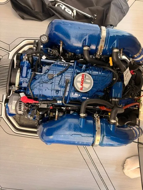Slide: The Image of A powerful engine with blue covers in a MasterCraft ProStar boat. - 15